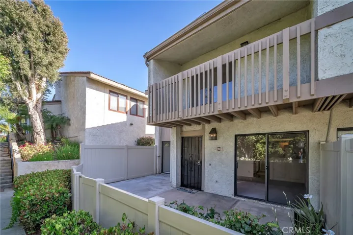 End unit with private patio and balcony.