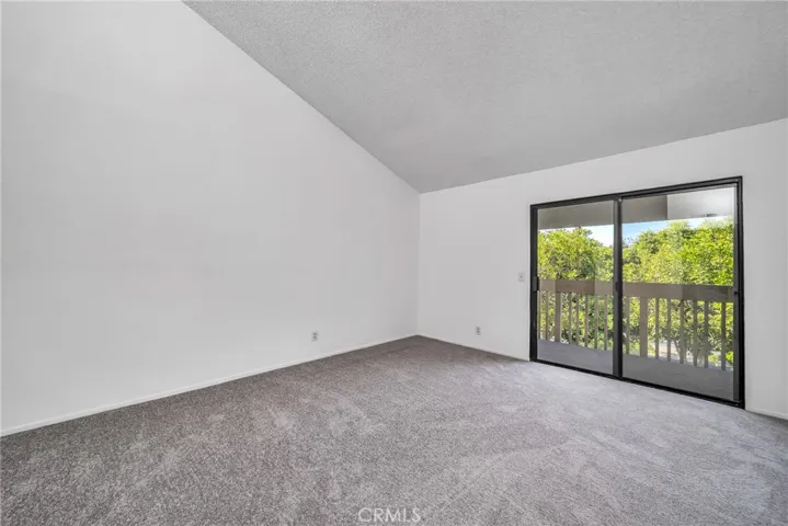 Master bedroom has vaulted ceilings and access to balcony.