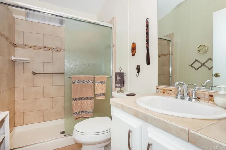 Upgraded bath features beautiful tile in shower and vanity.