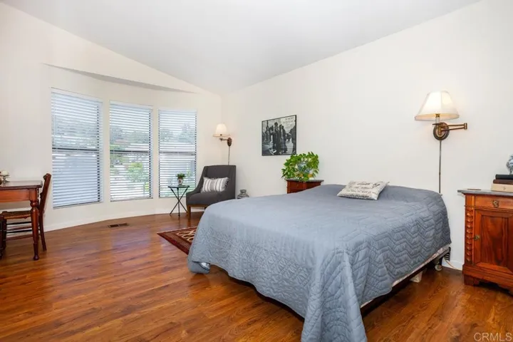 With room for a sitting area to read by the large bay windows.