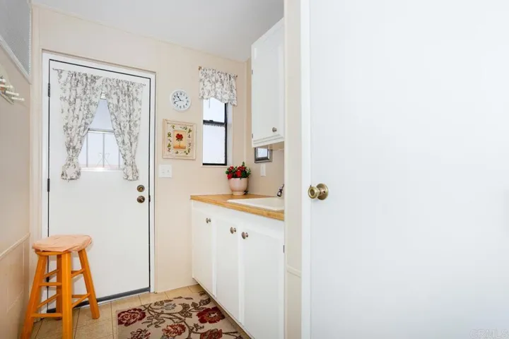 Spacious laundry room includes washer, dryer, deep sink, closet and more cabinet space!