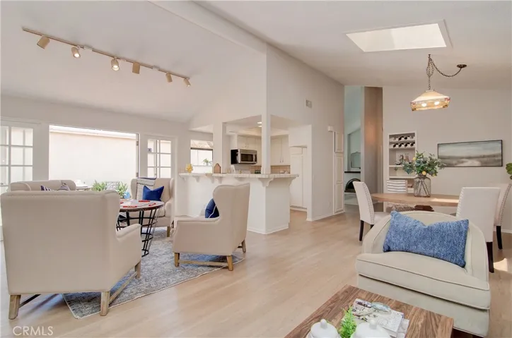 Now this is a GREAT room!  Multiple dining/living spaces, vaulted ceilings and French doors to outdoor areas.