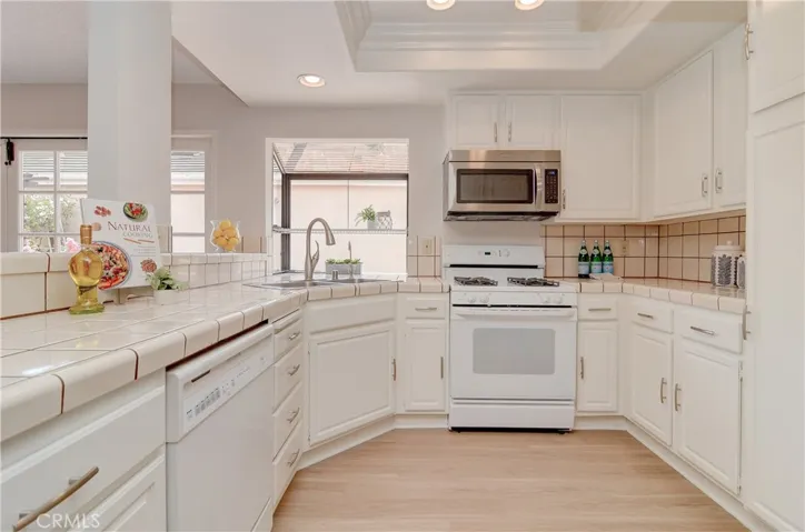 The chef is always part of the action in this sparkling kitchen with garden window and dining bar that opens to great room.