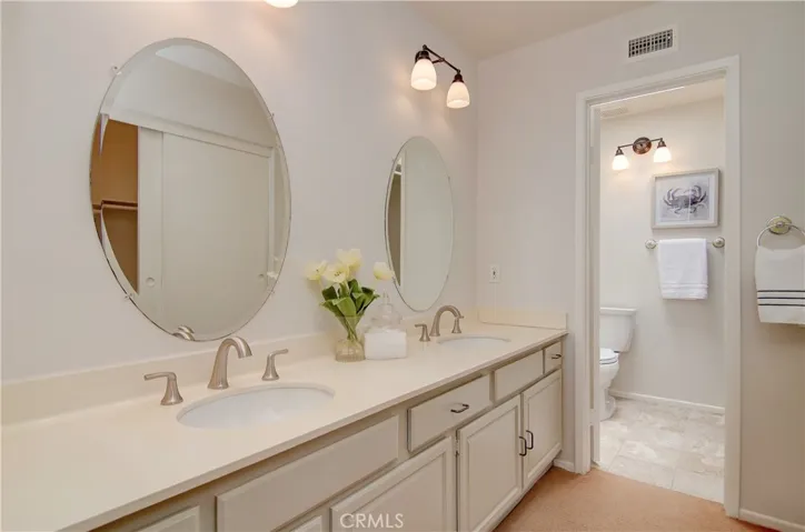 Master bath has dual sink vanity and separate bath area.