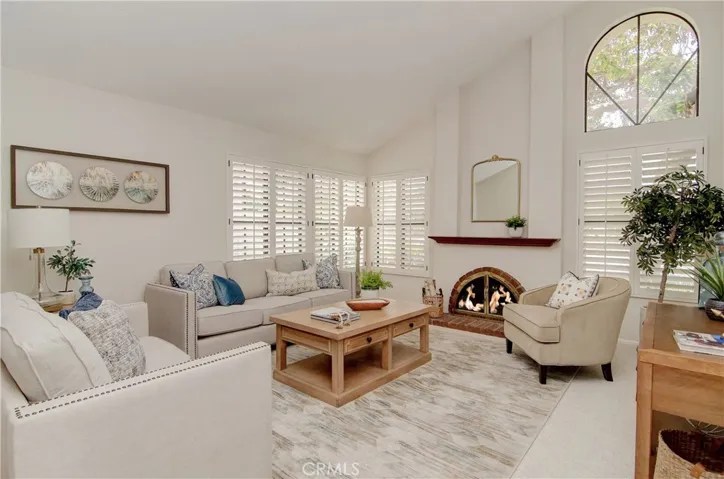 Large, Separate living room has wood burning fireplace and vaulted ceilings...could be an awesome home theatre/media/entertainment space too.