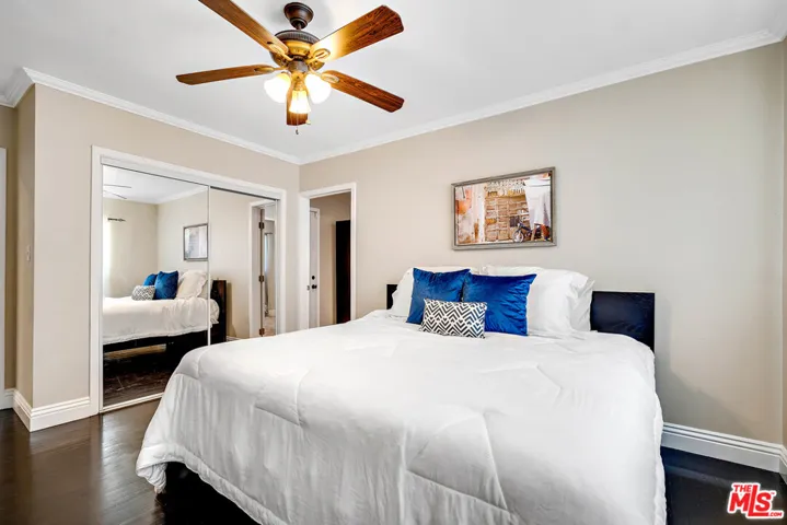 mirrored closet and ceiling fan