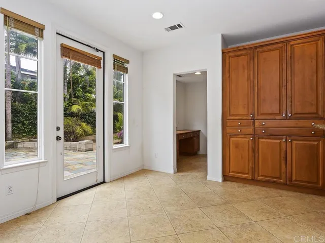 Informal eating area looking to backyard. Access to bedroom 5, desk & full bathroom.