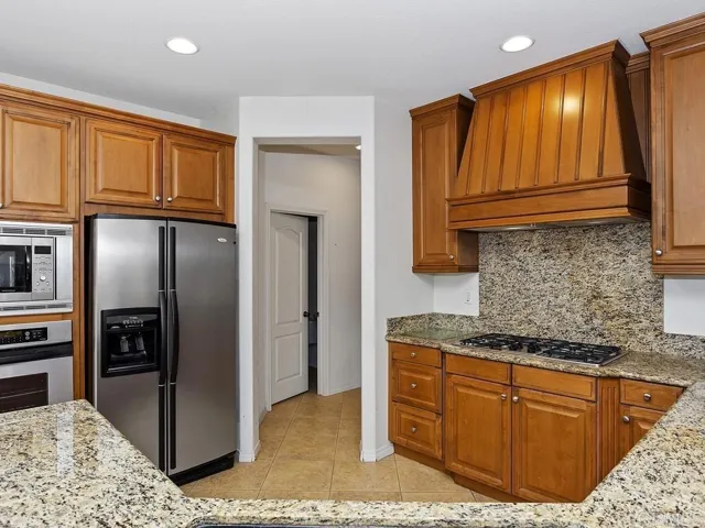 Kitchen with hall access to powder room and formal dining room.