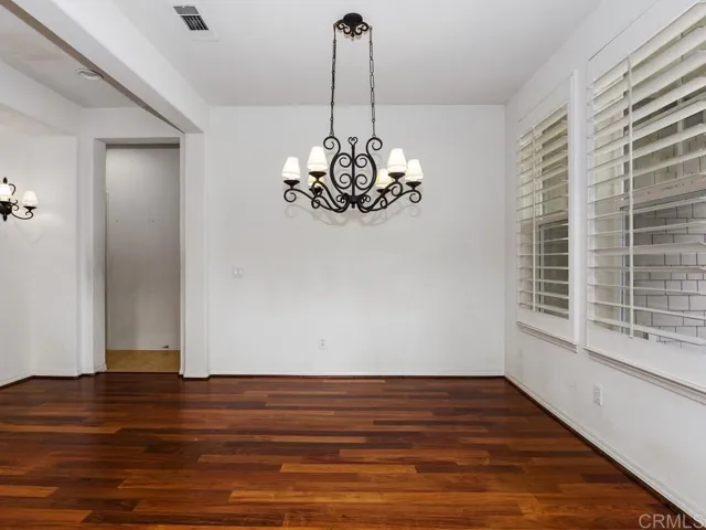 Dining room opens to living room and has hall access to powder room and kitchen.