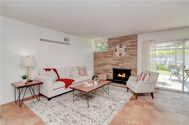 More Mid-Century details inside with horizontal stone fireplace and loads of windows.