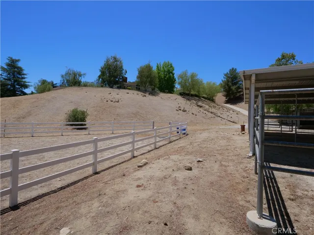 Home sits up on hill. There is a separate driveway or steps down to barn and ADU.