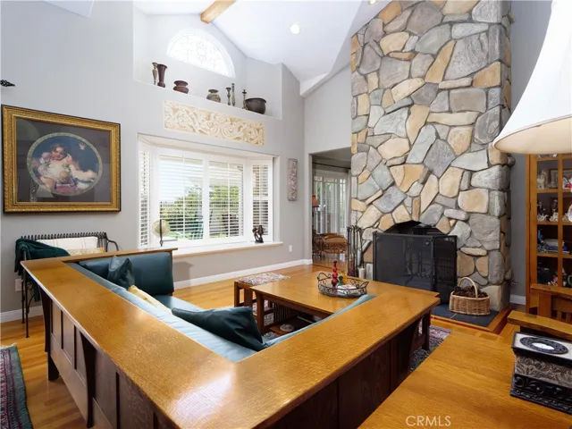 Formal living rm with beautiful see through stone fireplace that goes through to the family room.