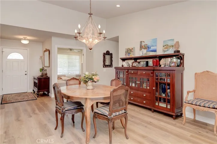 Vaulted ceiling makes this formal living room (or dining room) feel even larger.