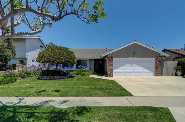 Street appeal to the max with lush lawn, mature landscape and brick accents...including covered front porch.