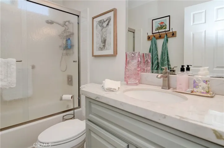 Gleaming hall bath with custom tub surround and more designer touches.