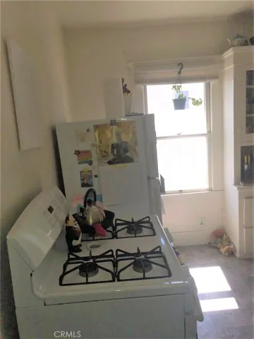 Kitchen at back of the house, with indoor laundry area by back door.