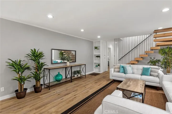 Inviting living room with fresh paint, new canned lighting and custom staircase