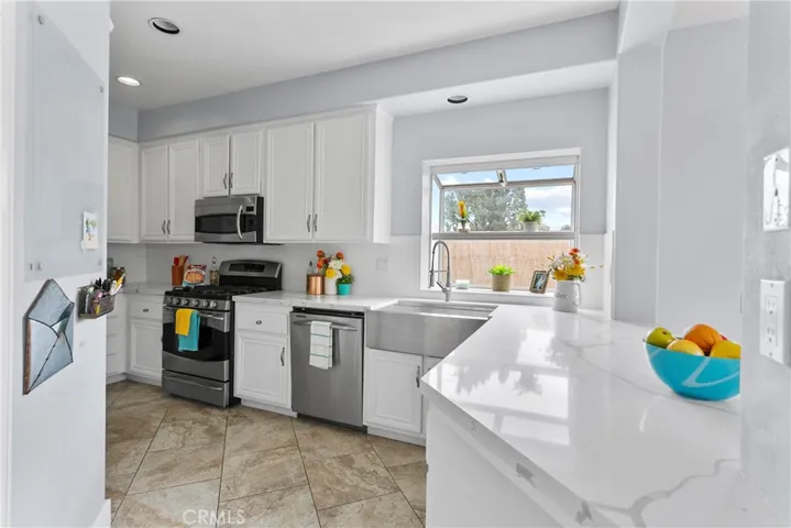Plenty of prep space here...gorgeous quartz counters and stainless farmhouse sink.