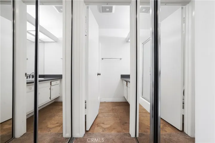 Double closets lead to primary bathroom