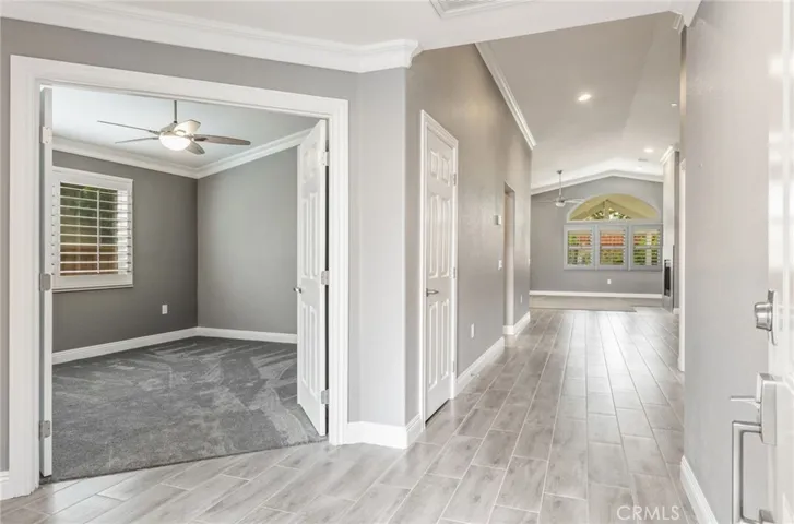 Entry foyer leading to office/bedroom and hall to great room