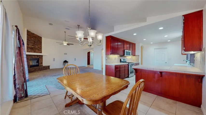 Large kitchen with newer LG stainless steel range and micro-hood.