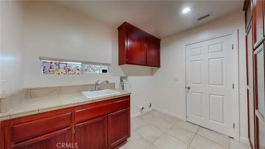 This is more than a Laundry room.  It is the exit to your garage, it can be a pantry and overflow room.  Fluff and fold, holiday prep, crafts...