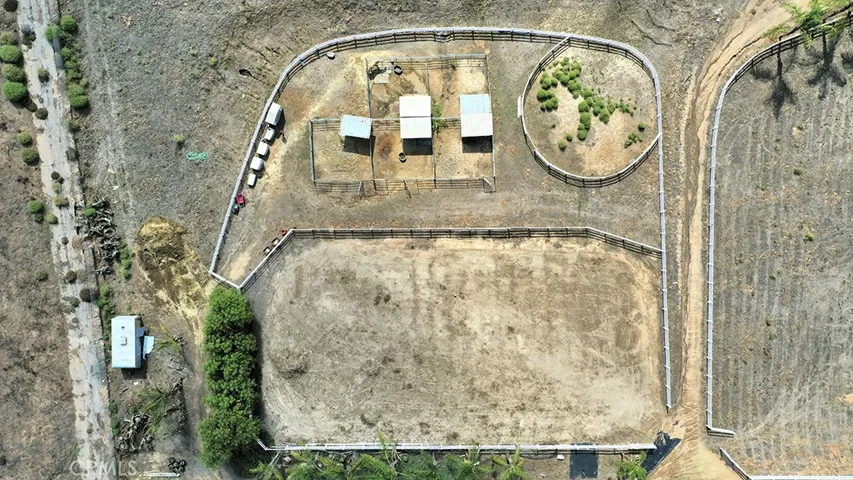 Equestrian area with 5 pipe corrals, round pen, arena and pasture.