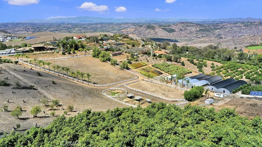 Looking from property corner to main house.  Greenhouses A, B, C, D on right side
