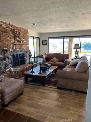 Den with fireplace, sliding doors open to beautiful views of the property.