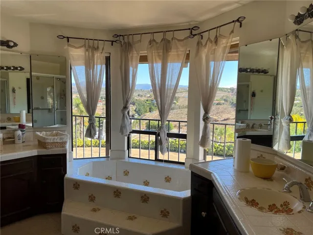 Master bath with dual vanities and tub