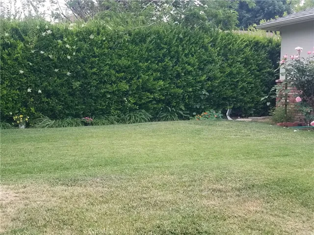 Side view of home has a natural wall for added privacy.