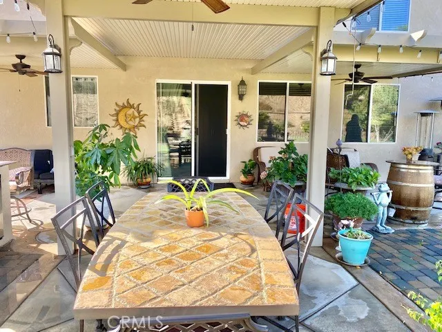 Covered patio area with 3 Ceiling fans