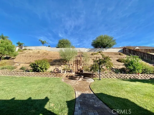 Stairs going up slope  and wood fire pit