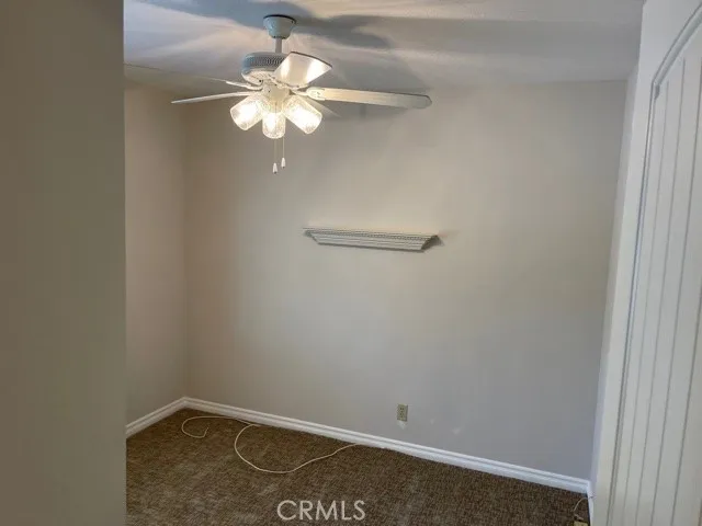 upstairs bedroom with ceiling light and fan.