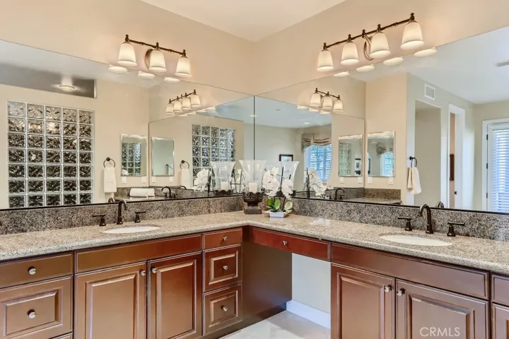Primary bathroom with dual sinks and vanity