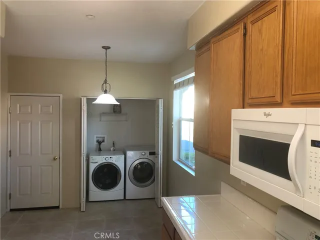 Breakfast area in kitchen with washer and dryer closet