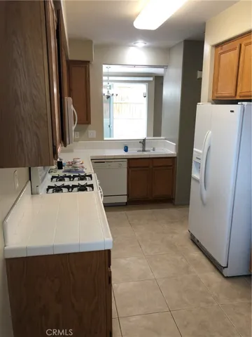 Galley kitchen with refrigerator