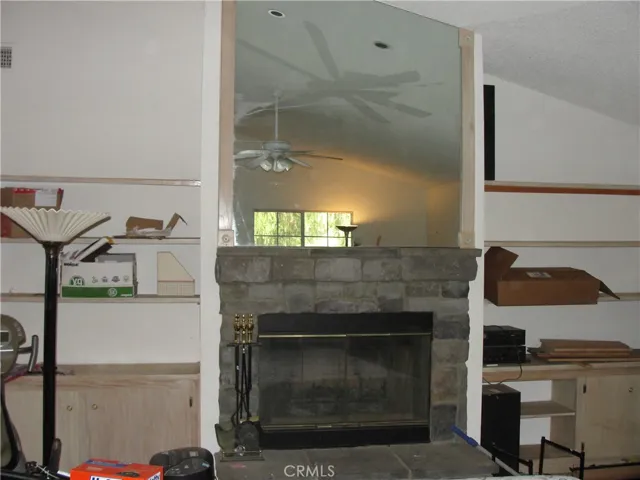 Stone fireplace with built in shelving.