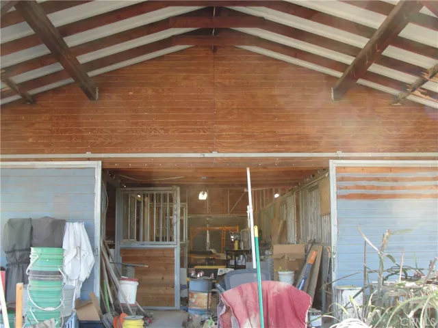 Closer view of barn entrance.  Huge double sliding doors for easy access in front and at back.  First 2 stalls are cement floors for great storage. Cement also down the center of barn for easy cleanup.