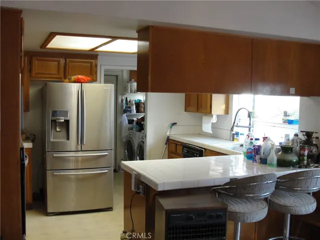 Kitchen area with large garden window.  In need of an update but completely functional.