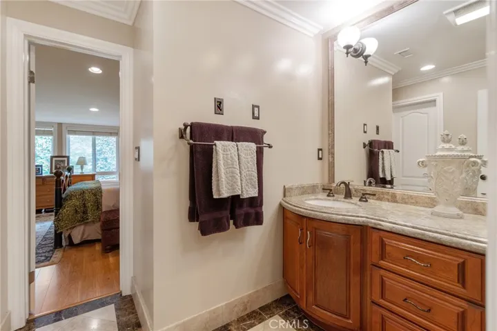 Master bath with granite counters and rich wood cabinets