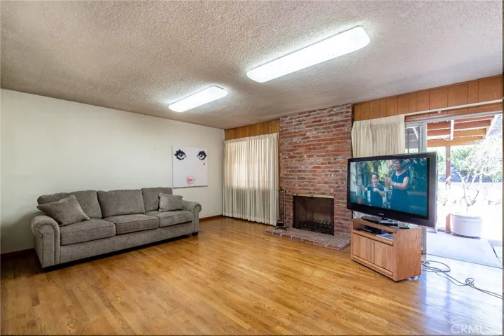 living room with fireplace & included TV and included sofa