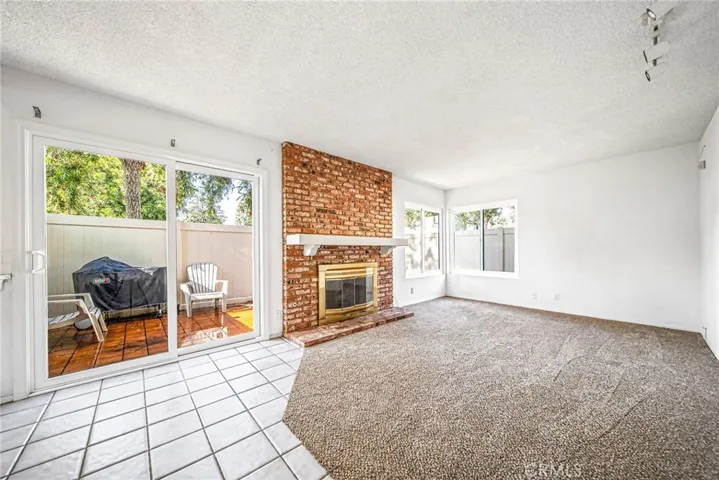 Family Room w/fireplace and slider to private patio.