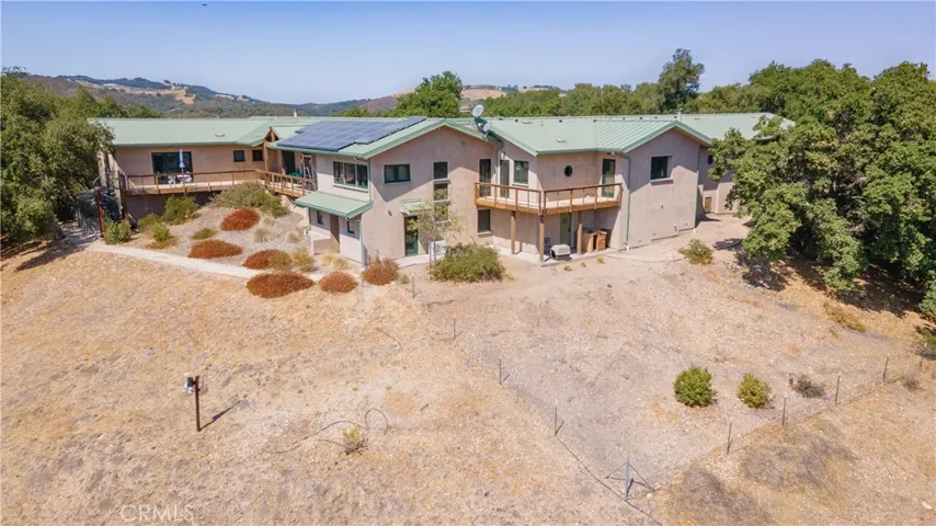 Left side (solar panel side) is the Main House. The bottom level of the Main House are the two extra bedrooms and extra bathroom. You can access those rooms from the deck door of the Guest House through the Main House Kitchen. Guest House is on the right of the TV satellite dish