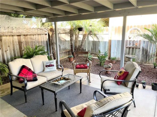 Covered patio area with beautiful trees & plants.
