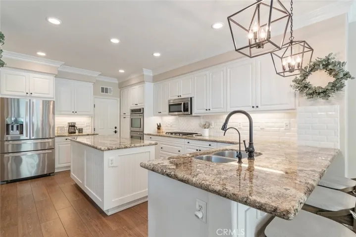 Newer cabinets, stainless steel appliances, contemporary light fixtures and granite countertops await you in your chef's kitchen.