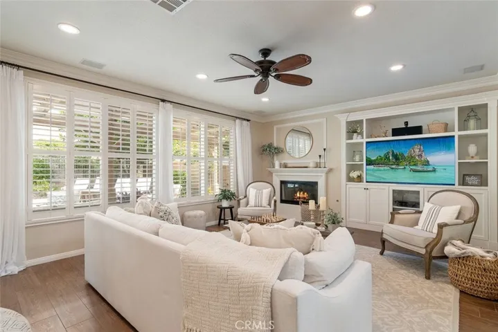 This open concept living room is warm and inviting, with pool views.