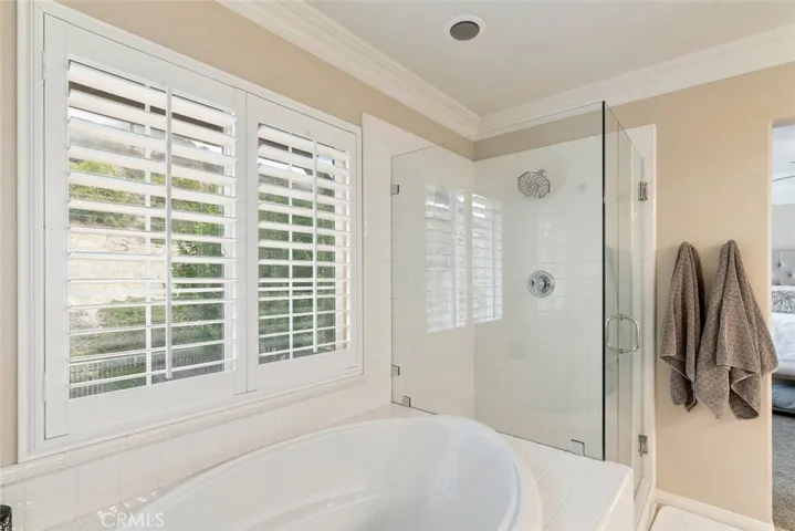 Updated shower, Crown moldings and plantation shutters, compliment your Master bath.