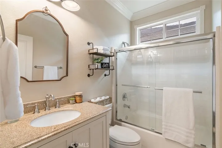 Downstairs full bath, complete with granite countertops and crown moldings.