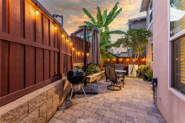 Tropical outdoor space with cafe lighting and drip irrigation.